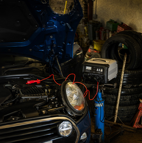Car with a jump starter in a garage setting