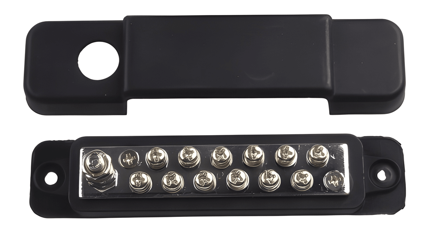 Top-down view showing the 12-point terminal screw layout on the brass bus bar alongside its corresponding black insulating cover.