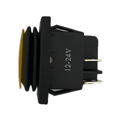 Side profile of the MURE SW85 amber switch highlighting the 12-24V dual-voltage rating, integrated waterproof rubber bellows, and secure panel-mounting clips.