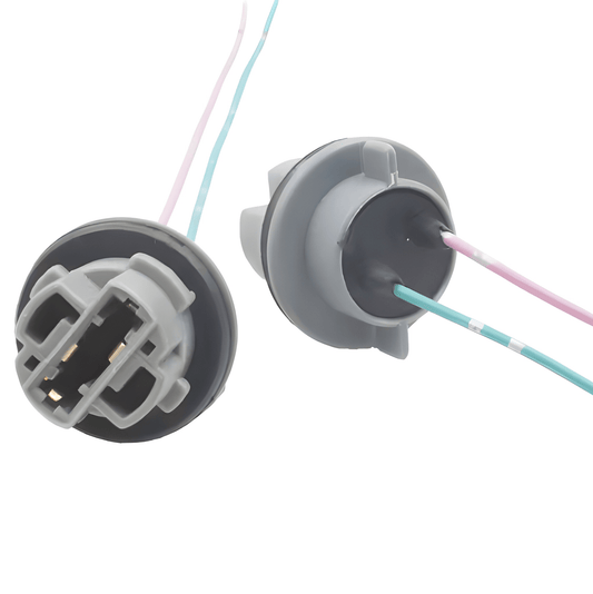 A dual-view image showing the interior terminal side and the sealed rear wiring side of a 12V T20/7440 wedge capless bulb holder with pre-installed pigtail wires.