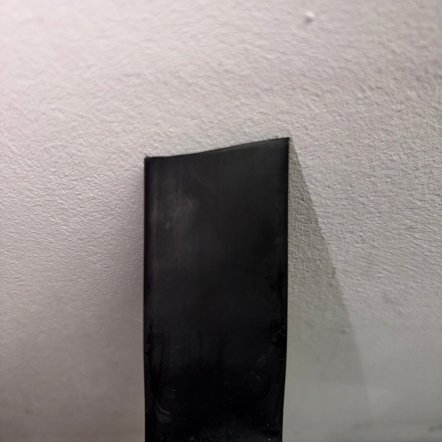 Close-up of black adhesive-lined heatshrink tubing from a 4M mini reel CHSMR31-19 1 against a white background