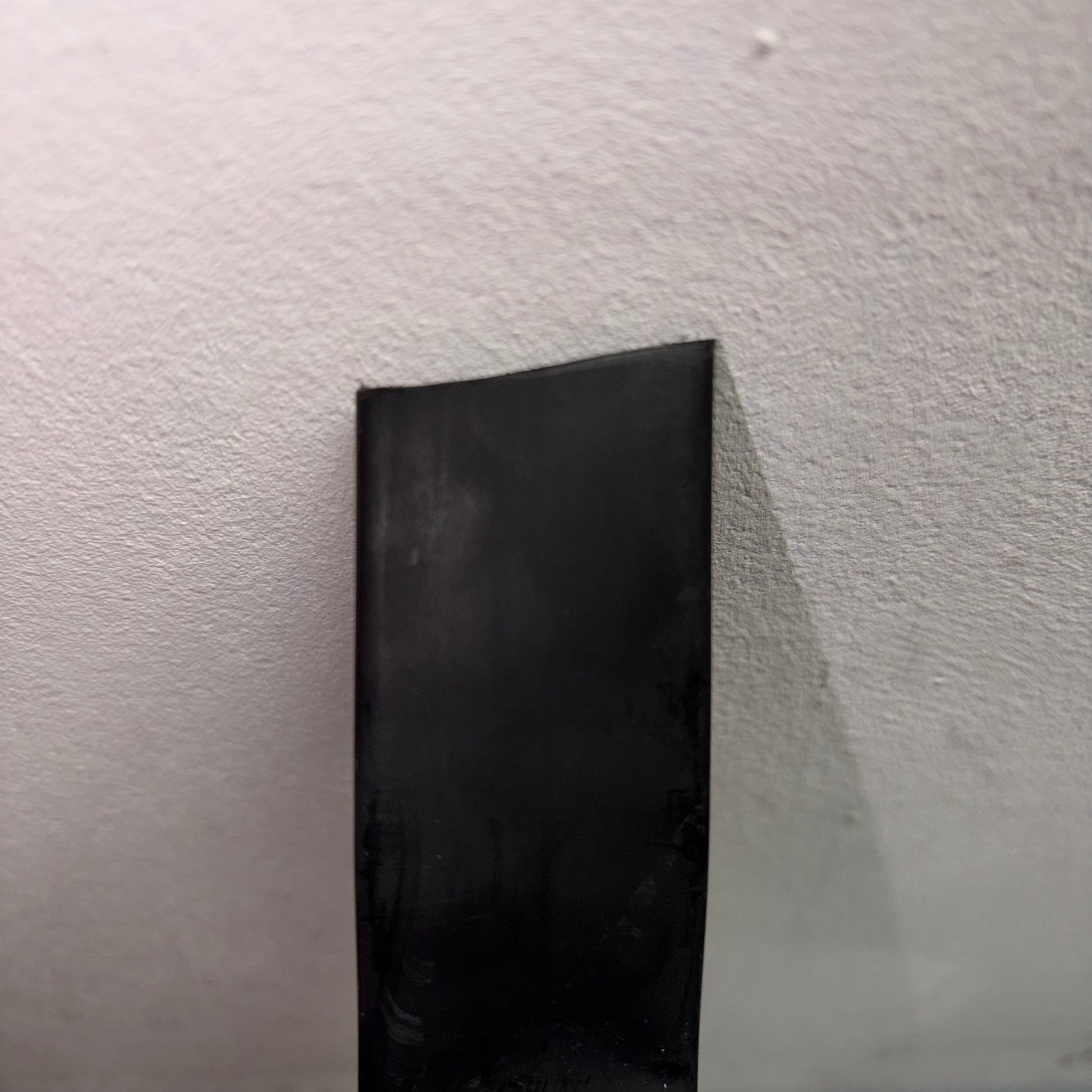 Close-up of black adhesive-lined heatshrink tubing from a 4M mini reel CHSMR31-19 1 against a white background