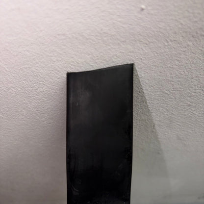 Close-up of black adhesive-lined heatshrink tubing from a 4M mini reel CHSMR31-19 1 against a white background