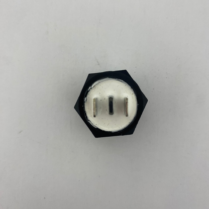 Black push botton momentary switch with a white center on a light gray background