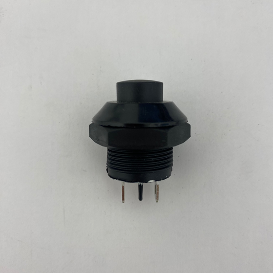 Black mechanical push button momentary switch on a white background