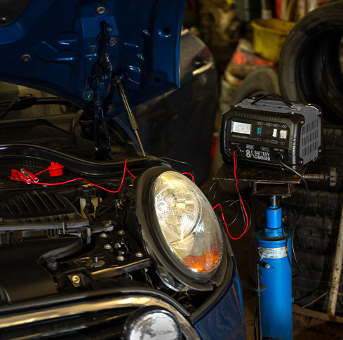 Car headlight repair with a battery pack in a garage setting