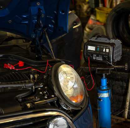 Car headlight repair with a battery pack in a garage setting