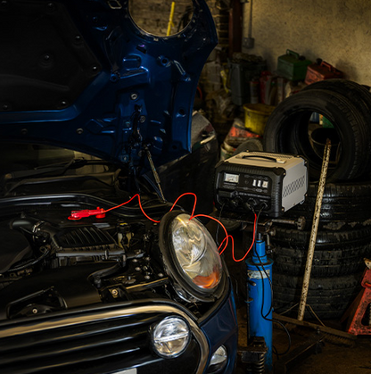 Car with a jump starter in a garage setting