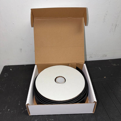 Open box containing a mini reel of black heatshrink tubing with white cardboard packaging.
