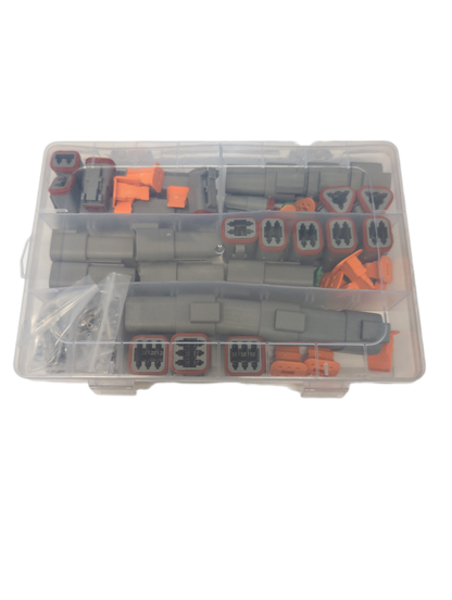 A clear plastic organizer case containing multiple gray and orange plastic deutsch connector pieces, photographed on a plain white background.