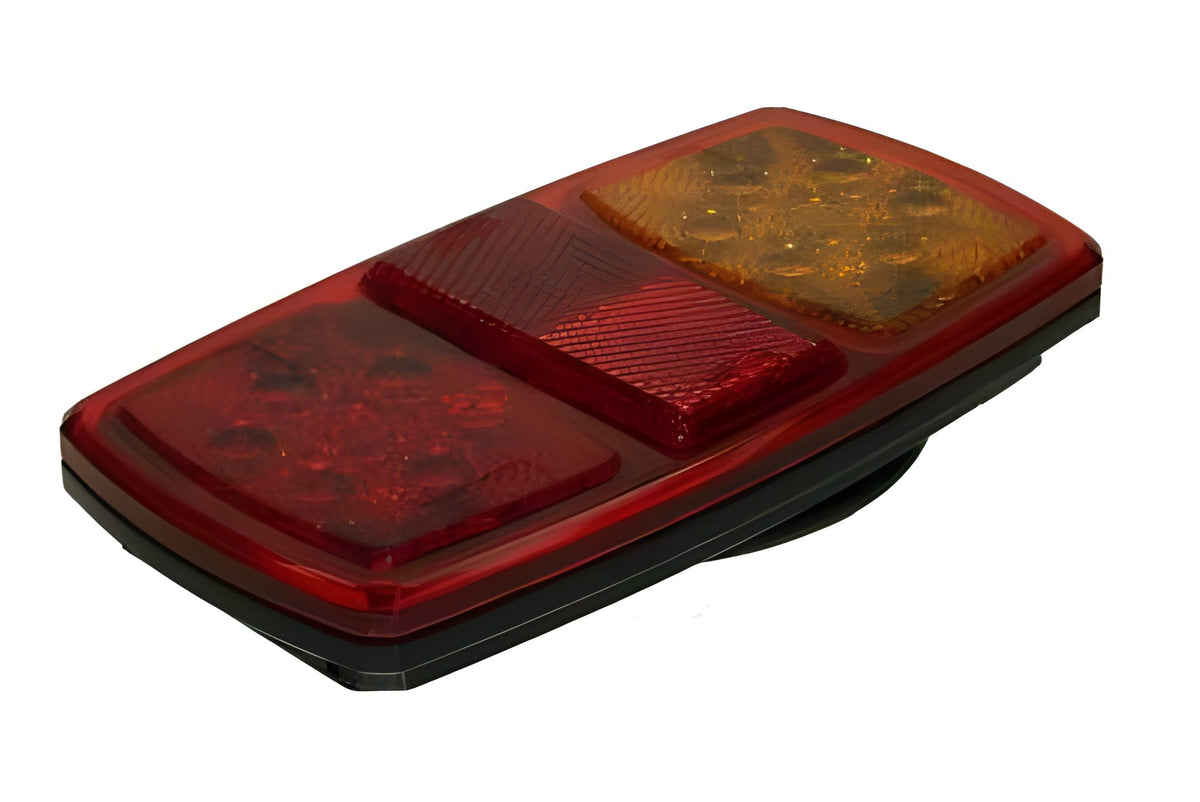 Red and amber trailer light on a white background
