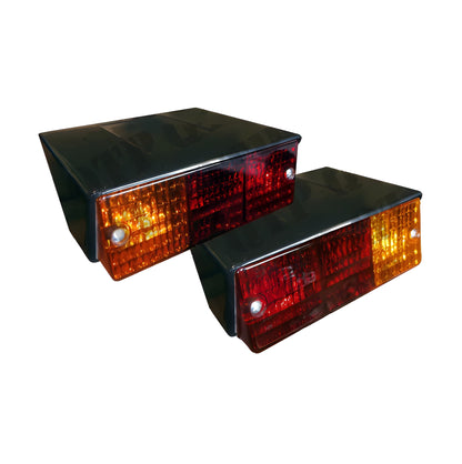 Two rectangular traffic lights with red and orange lenses on a white background