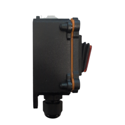 A black plastic electrical junction box with a red toggle switch and a copper-colored rubber gasket, isolated on a white background.