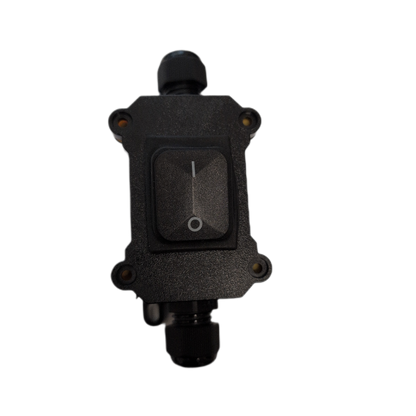 A black waterproof outdoor rocker switch with a textured housing, a recessed rocker button with a white line symbol, and threaded connector ports at the top and bottom, isolated on a white background.